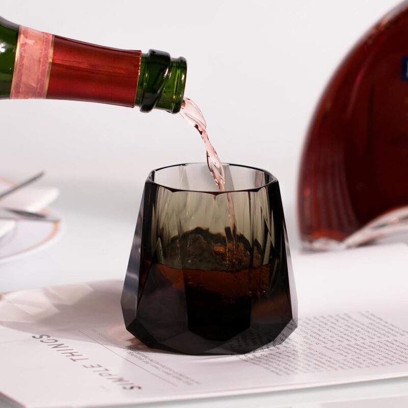 Smoky faceted KAMMAK whiskey glass receiving a measured pour