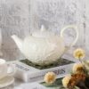 KAMMAK Teapot with Handle, Vintage Porcelain Tea Pot with Gold Trim, Blooming & Loose Leaf Teapot, Festive Holiday Serveware, Gifts for Women, Creamy White 28 oz KAMMAK 8CZSY011 ceramic teapot close-up material texture detail image 4