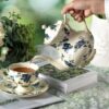 KAMMAK Teapot with Handle, Vintage Porcelain Tea Pot with Gold Trim, Blooming & Loose Leaf Teapot, Festive Holiday Serveware, Gifts for Women, Blue Flowers 30 oz KAMMAK 8CZSY019 ceramic teapot side angle view showing silhouette