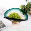 KAMMAK Glass Fruit Bowl, Luxury Centerpiece Glass Bowl, Hand Blown Decorative Dessert Plate, Green Aesthetic Counter Decor, Colored Modern Art Serving Bowls for Party (SXY04) KAMMAK 8GPSXY004 decorative serving plate side angle view showing silhouette