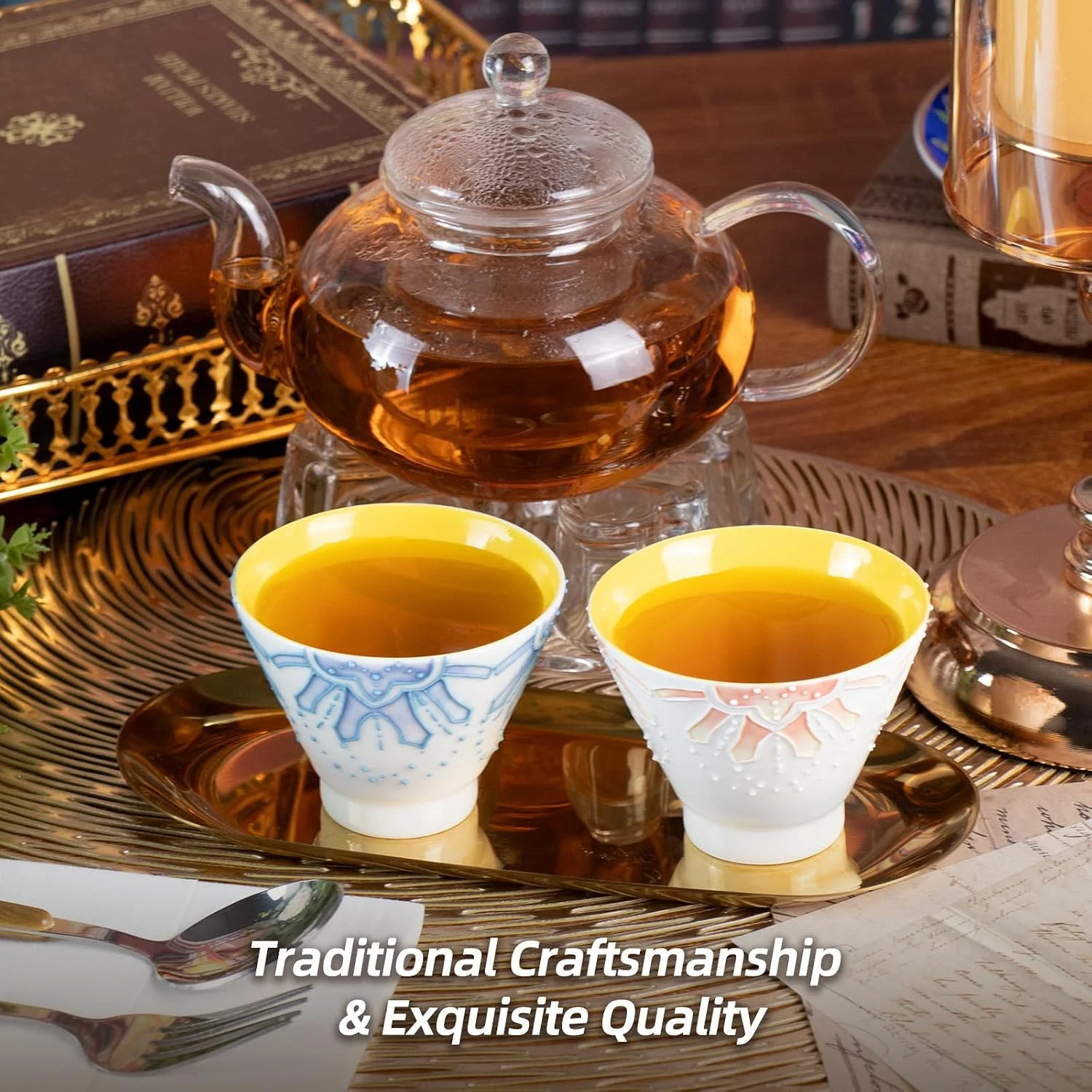 Orange and blue KAMMAK tea cups served beside a glass teapot
