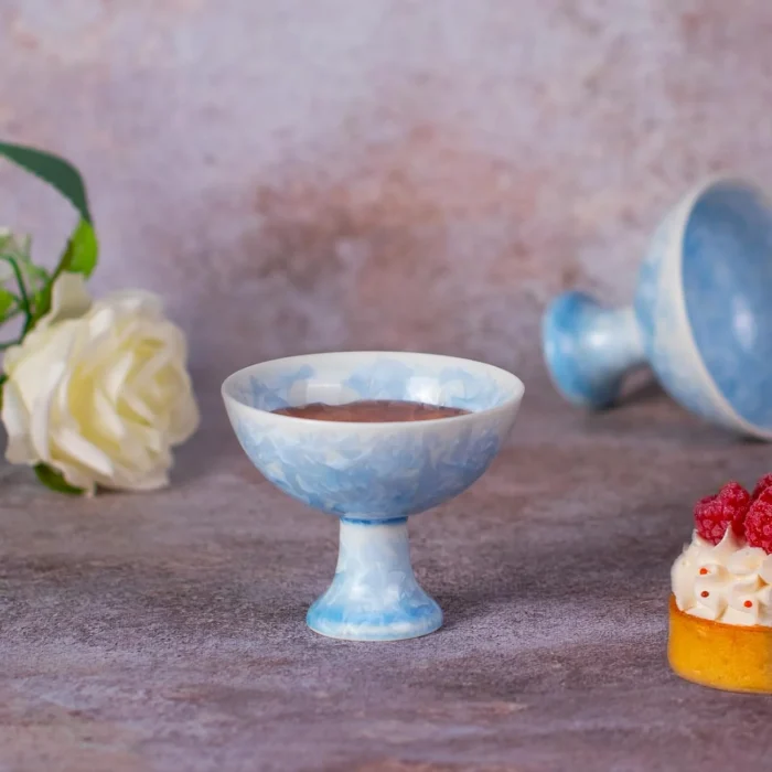Single blue crystalline glaze pedestal cup filled with tea KAMMAK 7KPSP792N ceramic cup and saucer close-up material texture detail image 4