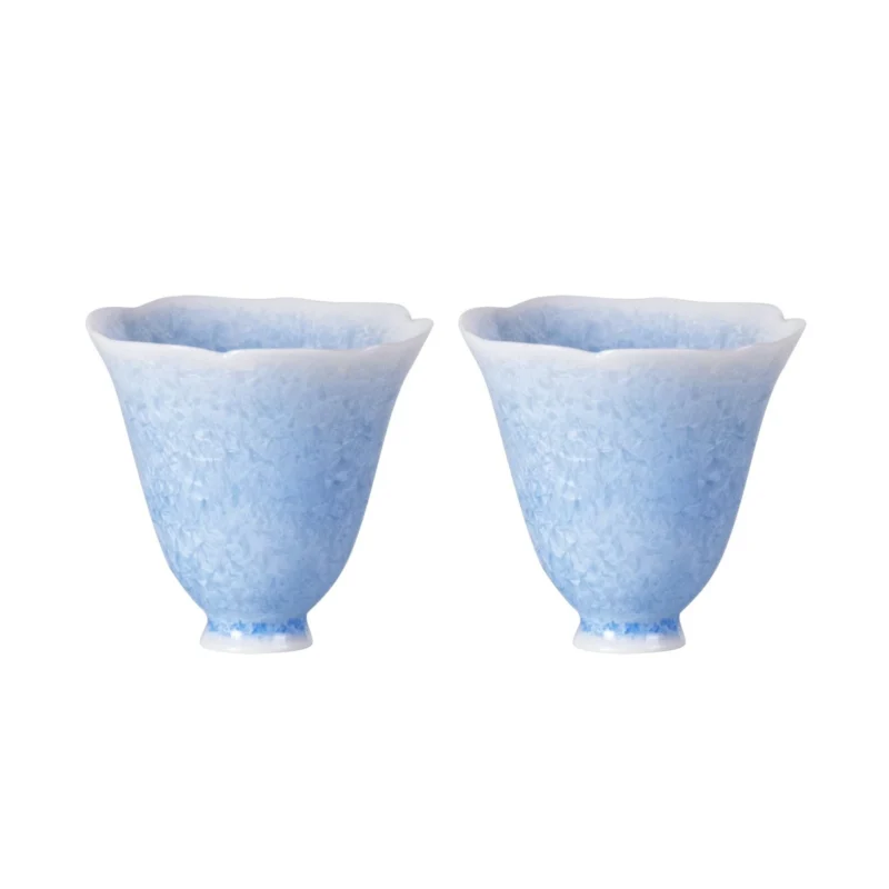Two blue crystalline-glaze porcelain tea cups with flared petal rims