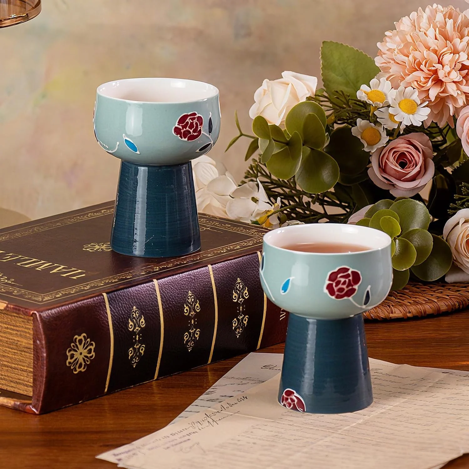 Pair of blue ceramic pedestal cups in a tea setting