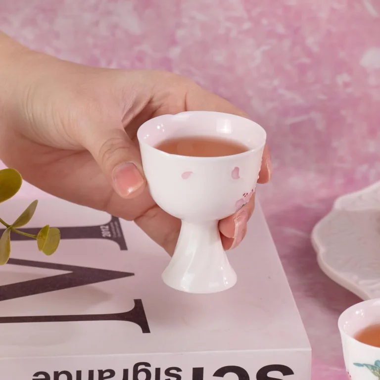 Slim butterfly porcelain tea cup held in one hand