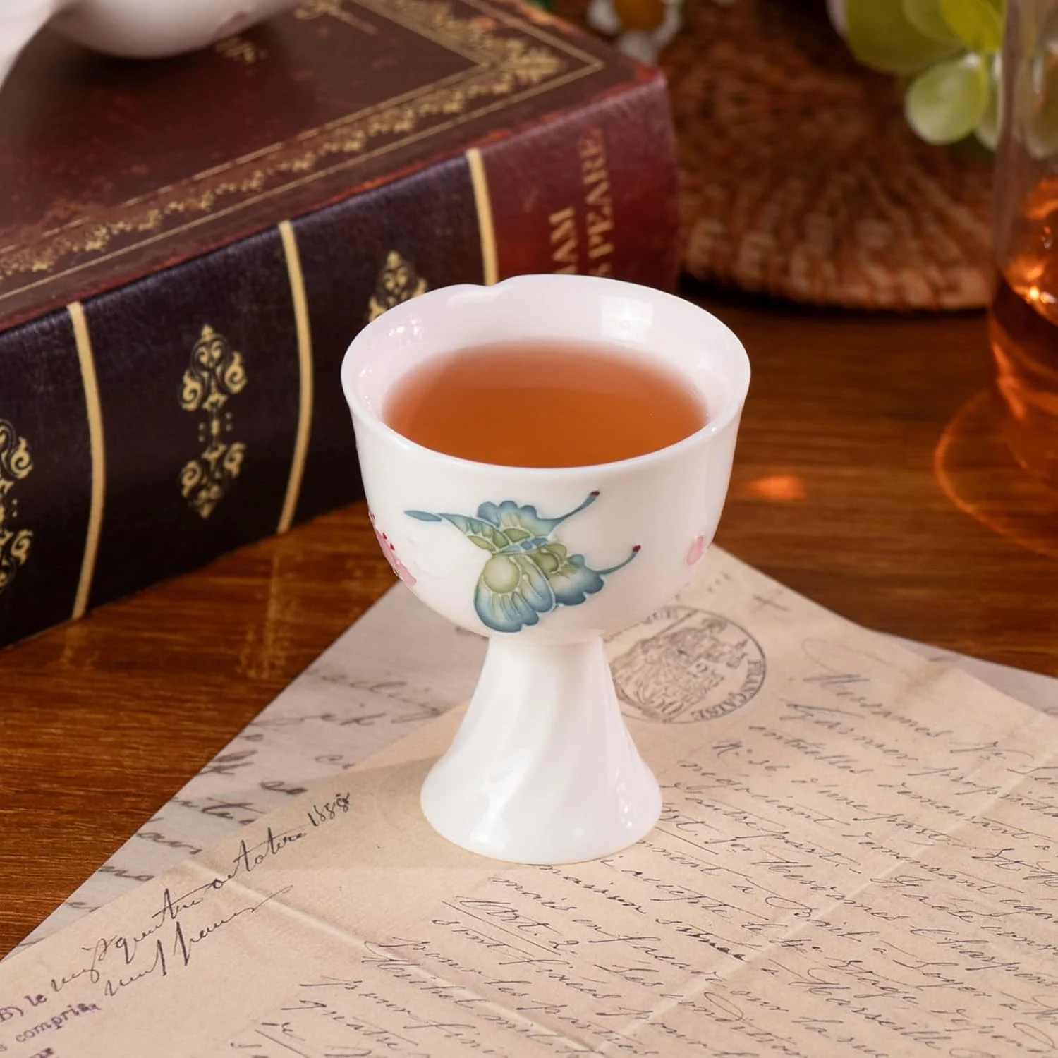 Butterfly porcelain tea cup filled with tea