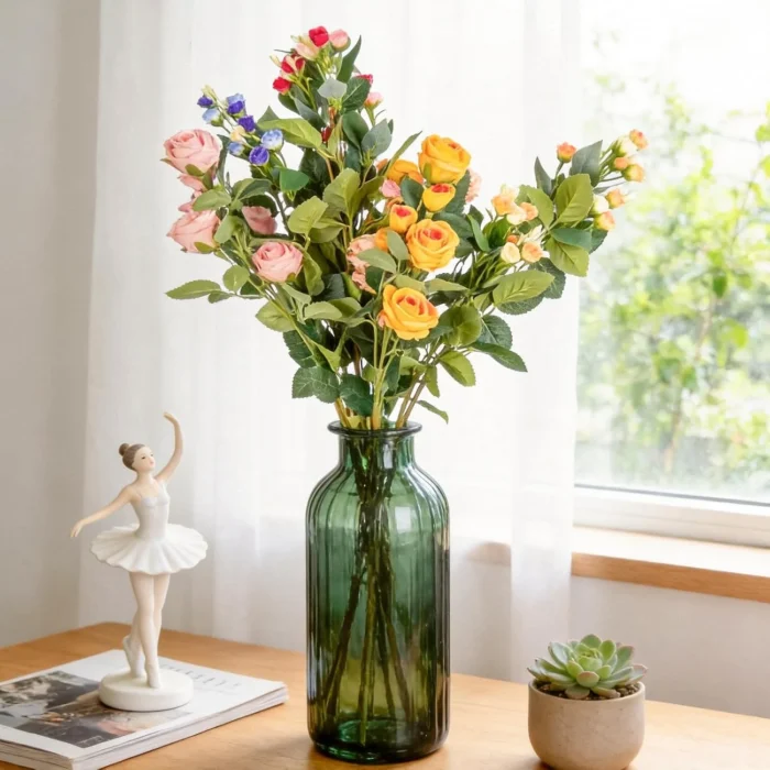 Mixed rose bouquet displayed in a green glass bottle KAMMAK 8KPFZH005 home decor product styled home decor setting image 5