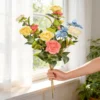 Colorful mixed rose bouquet held next to a window KAMMAK 8KPFZH011 home decor product side angle view showing silhouette