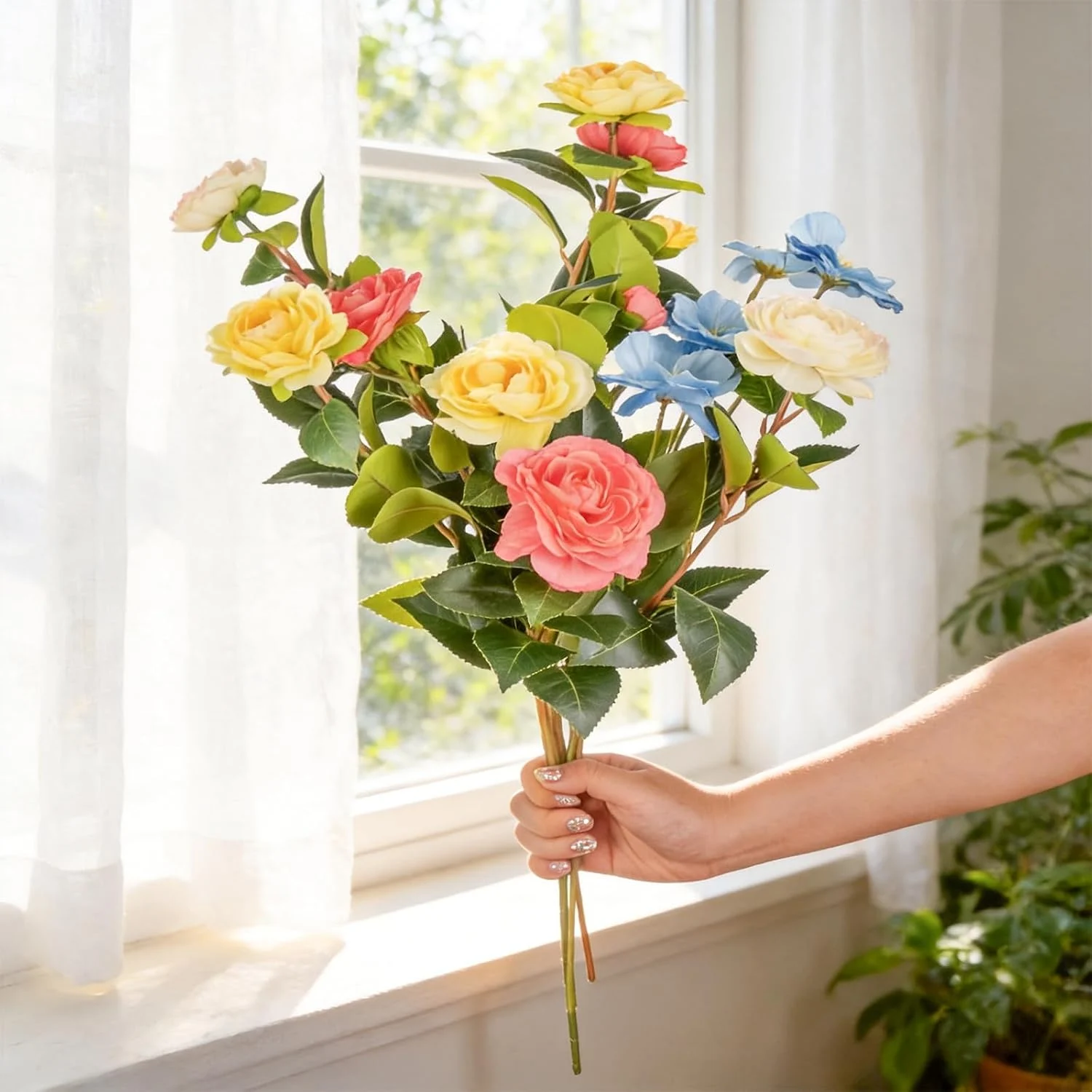 Colorful mixed rose bouquet held next to a window