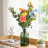Tall colorful flower stems in a green glass bottle KAMMAK 8KPFZH011 home decor product styled home decor setting image 5