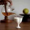 Tea poured into the white short-stem ceramic cup KAMMAK 7KPSP692N+693N ceramic cup and saucer scale and proportion view image 6