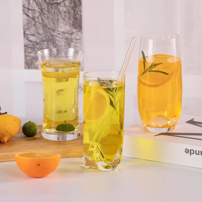 Three tall crystal glasses filled with yellow and orange beverages KAMMAK 7KPSP776N home decor product scale and proportion view image 6