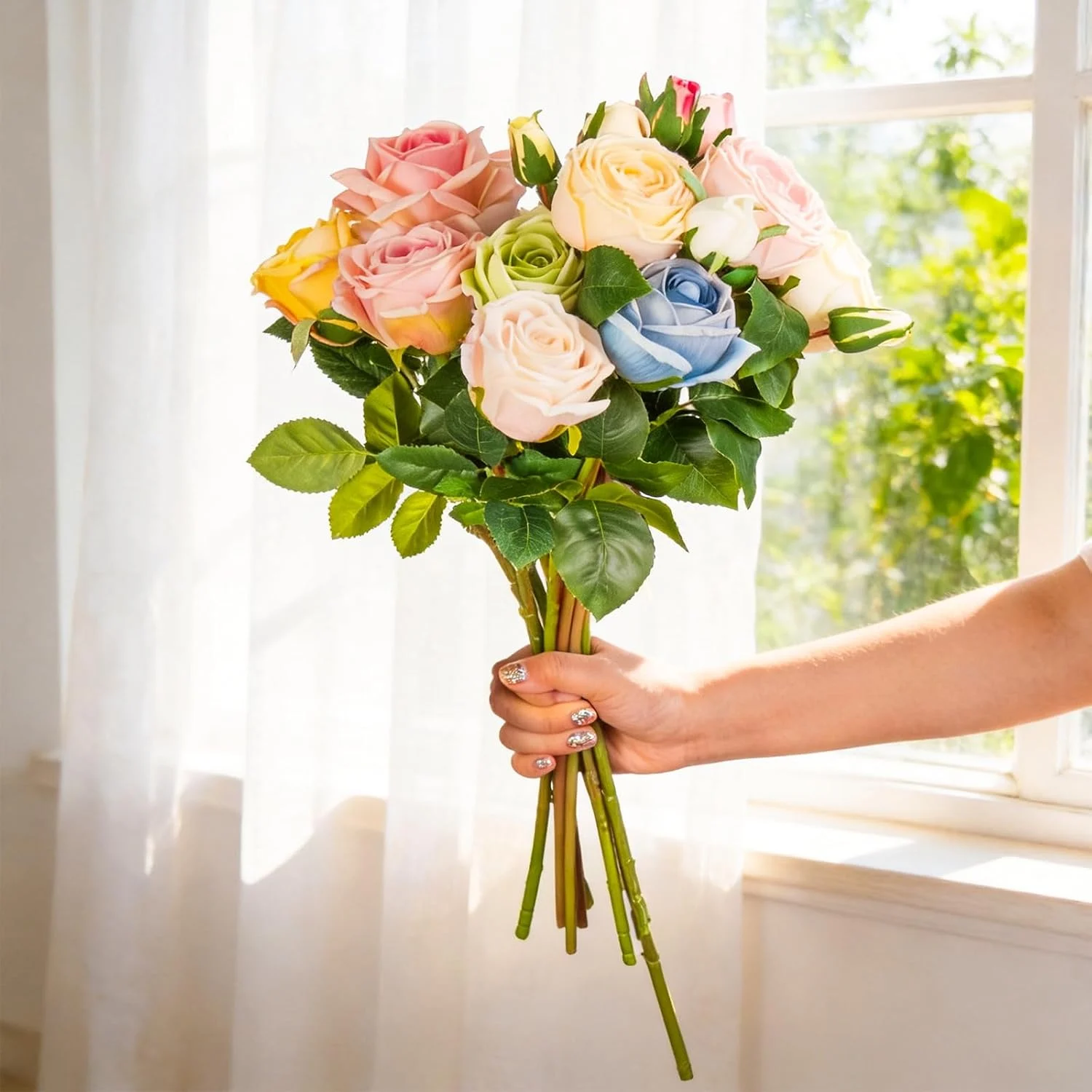 Full pastel rose bouquet held beside a sunny window