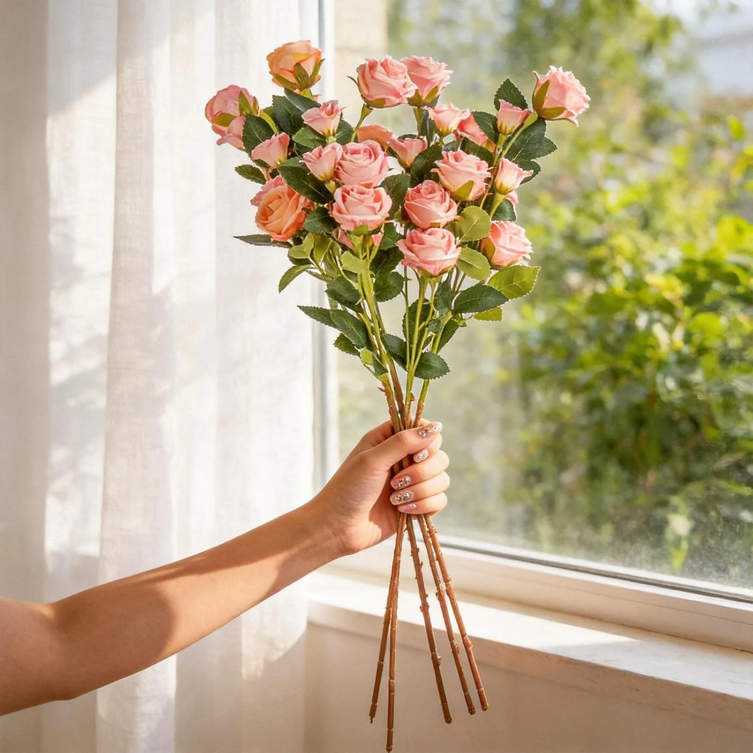 Long artificial rose bundle held beside a bright window