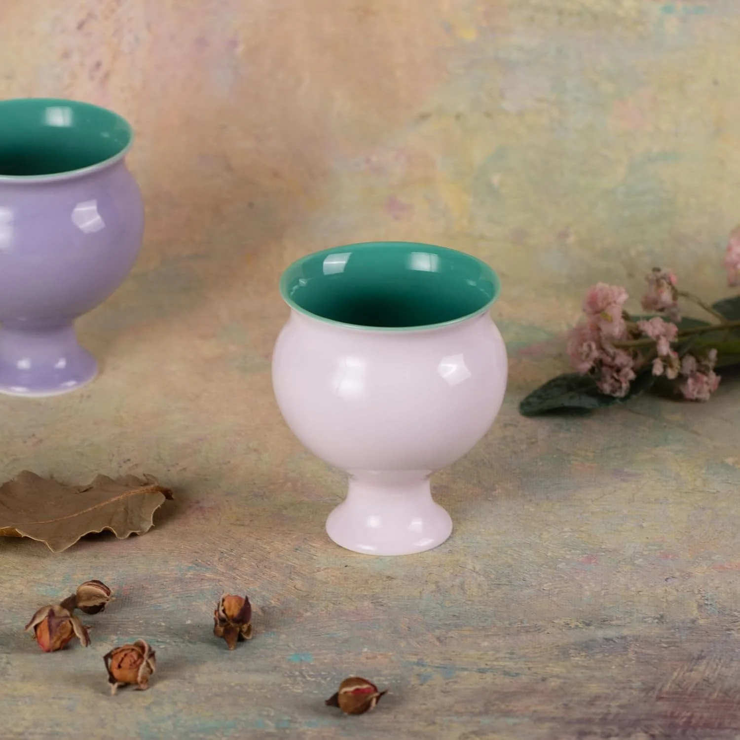 Apricot pink ceramic tea cup with green interior