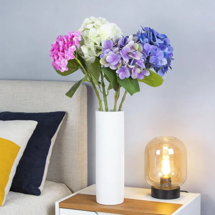 Mixed hydrangea arrangement in a white vase beside a sofa KAMMAK 8KPFZH008 home decor product decorative craft detail image 7