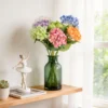 Colorful hydrangea bouquet displayed in a green glass bottle KAMMAK 8KPFZH009 home decor product styled home decor setting image 5