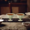 Green porcelain tea cup pair on a tea table KAMMAK 7KPSP701N ceramic cup and saucer scale and proportion view image 6