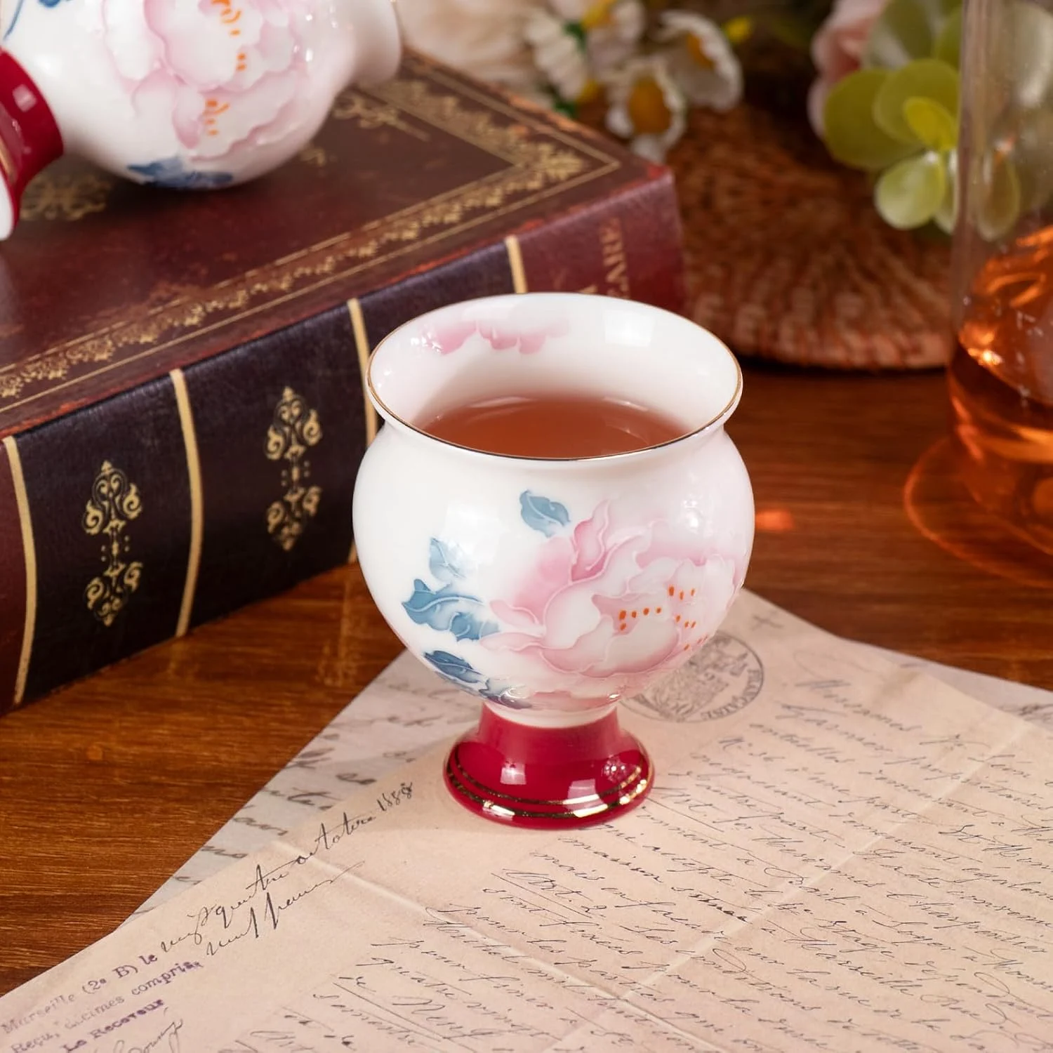 Single round peony porcelain cup filled with tea