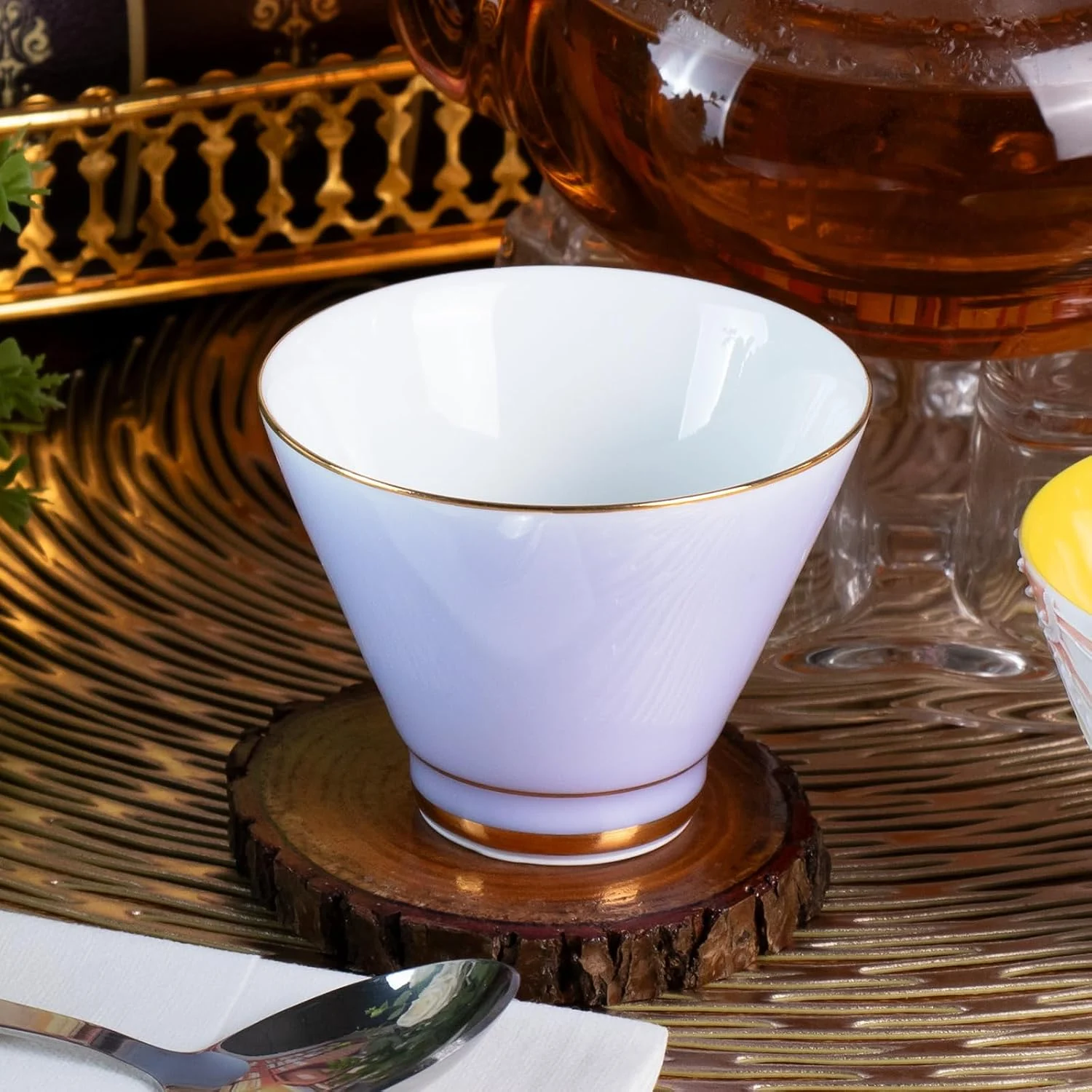 Single lavender KAMMAK tea cup with white interior and gold-tone rim