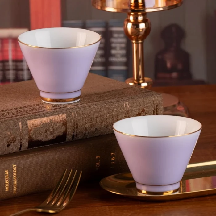 Lavender KAMMAK ceramic cups displayed on stacked books KAMMAK 7KPSP432N ceramic cup and saucer styled home decor setting image 5