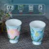 KAMMAK lily-pattern footed tea cups with care guidance icons KAMMAK 7KPSP734N+735N-US ceramic cup and saucer side angle view showing silhouette