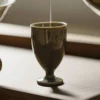 Tea being poured into an olive green KAMMAK high-footed cup KAMMAK 7KPSP694N+695N ceramic cup and saucer close-up material texture detail image 4