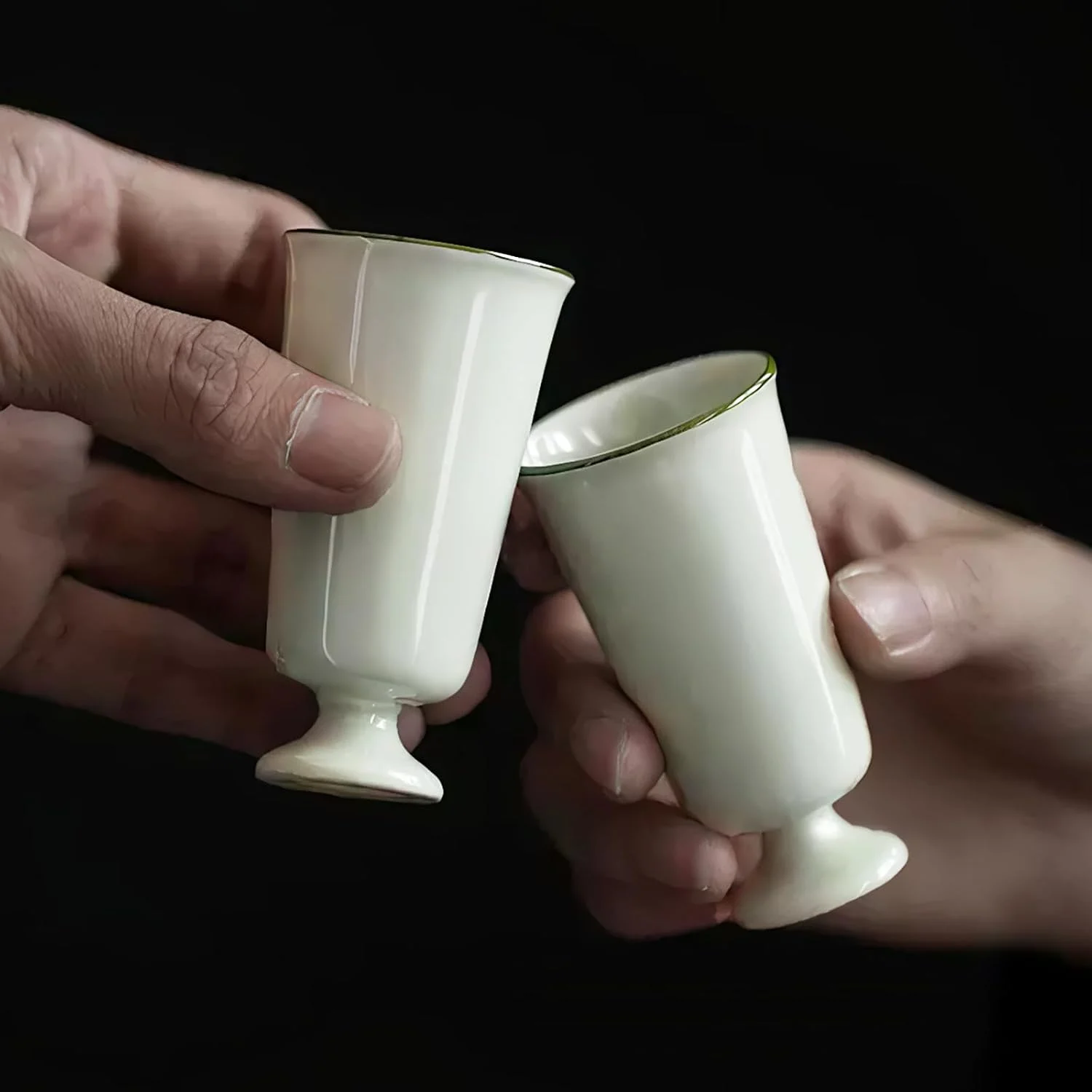 Two KAMMAK 718N footed cups being gently tapped together