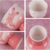 KAMMAK 714N cup close-ups showing raised pink flowers, white interior and foot KAMMAK 7KPSP714N ceramic cup and saucer close-up material detail image 4