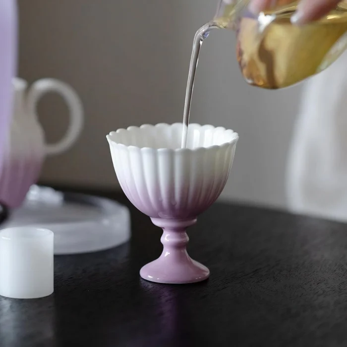 Tea being poured into a purple KAMMAK chrysanthemum footed cup KAMMAK 7KPSP702N ceramic cup and saucer scale and proportion view image 6