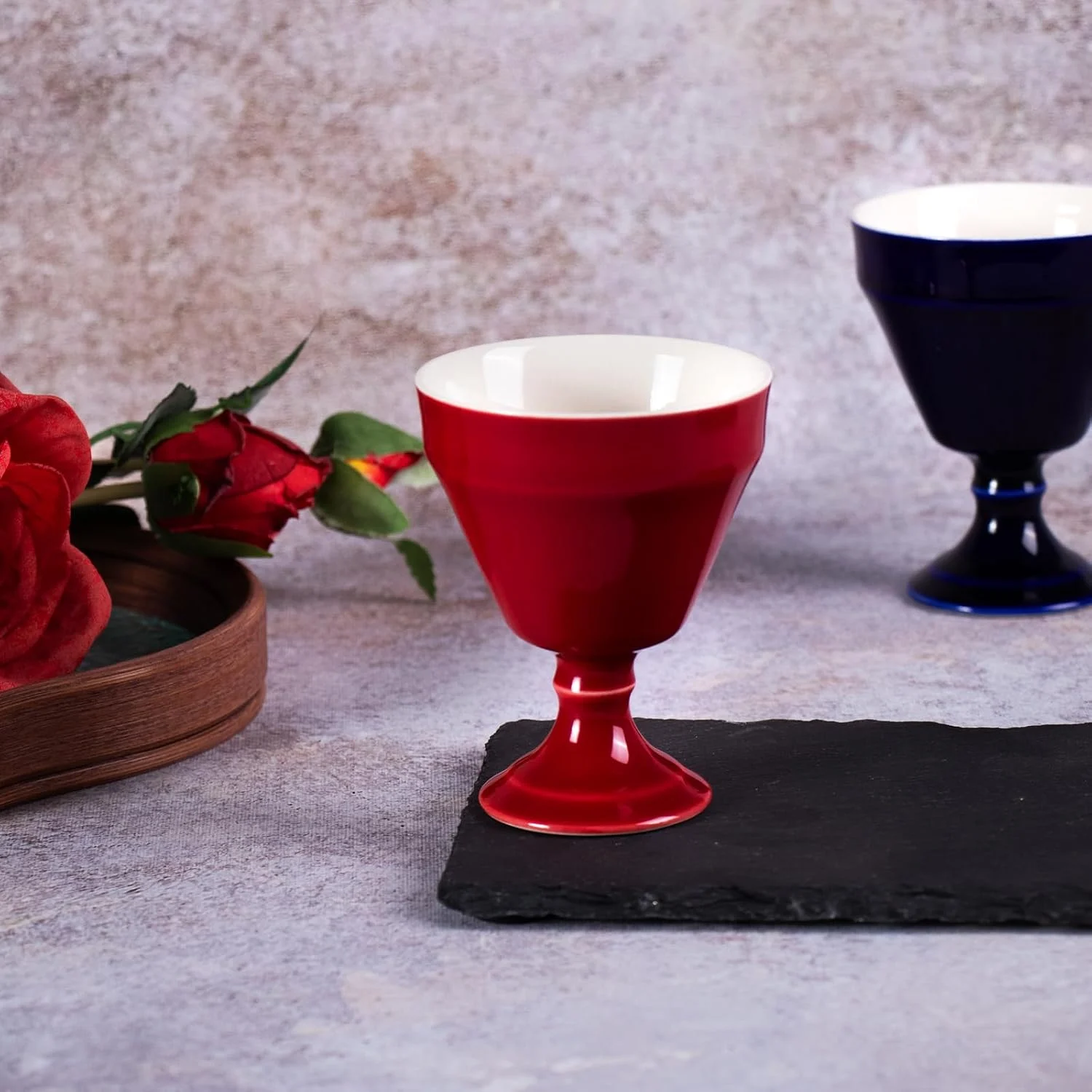 Single glossy red KAMMAK 680N footed tea cup on slate