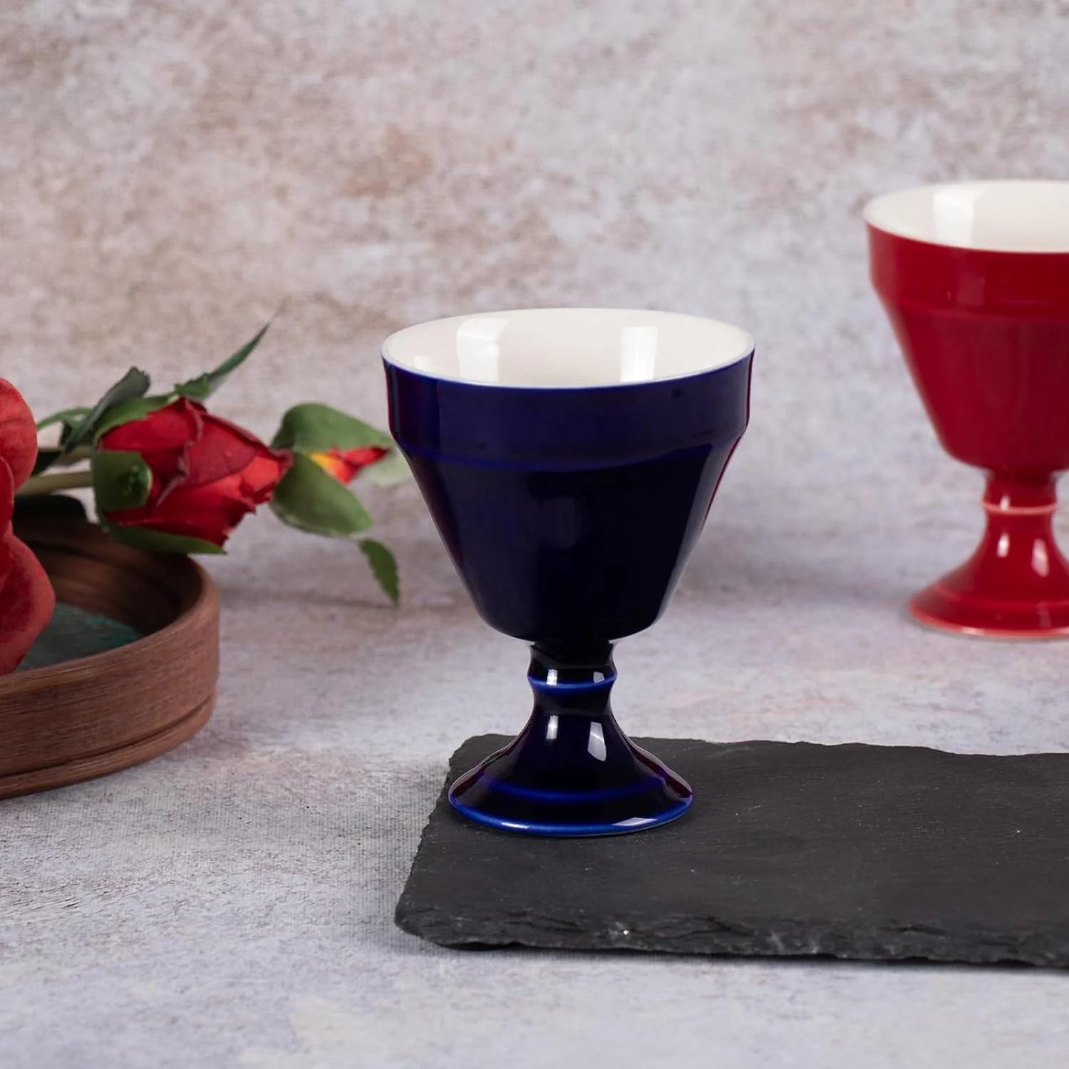 Single navy KAMMAK 681N footed tea cup displayed beside flowers