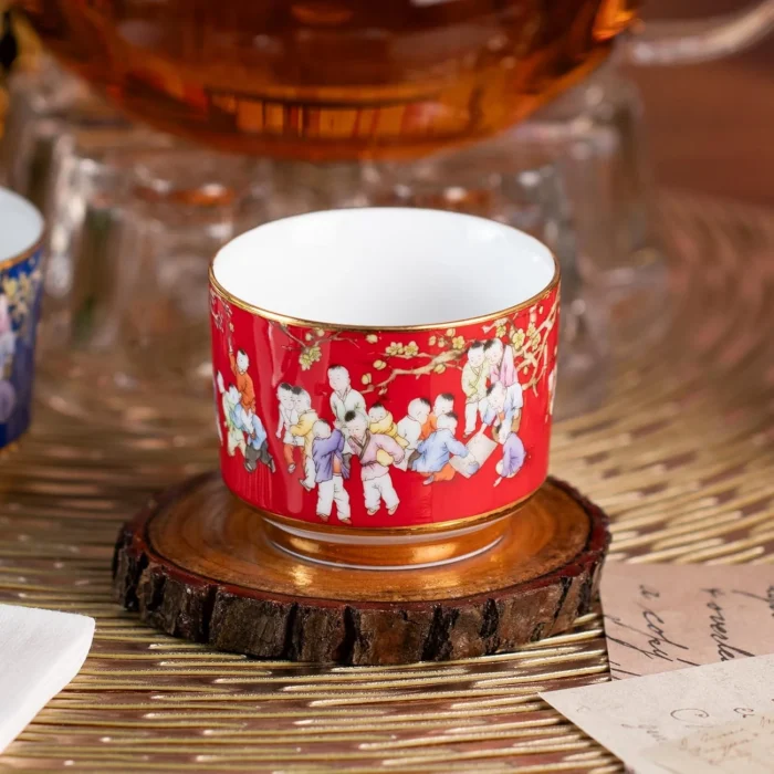 Close view of the red KAMMAK porcelain tea cup and gold-tone trim KAMMAK 7KPSP424N ceramic cup and saucer styled home decor setting image 5