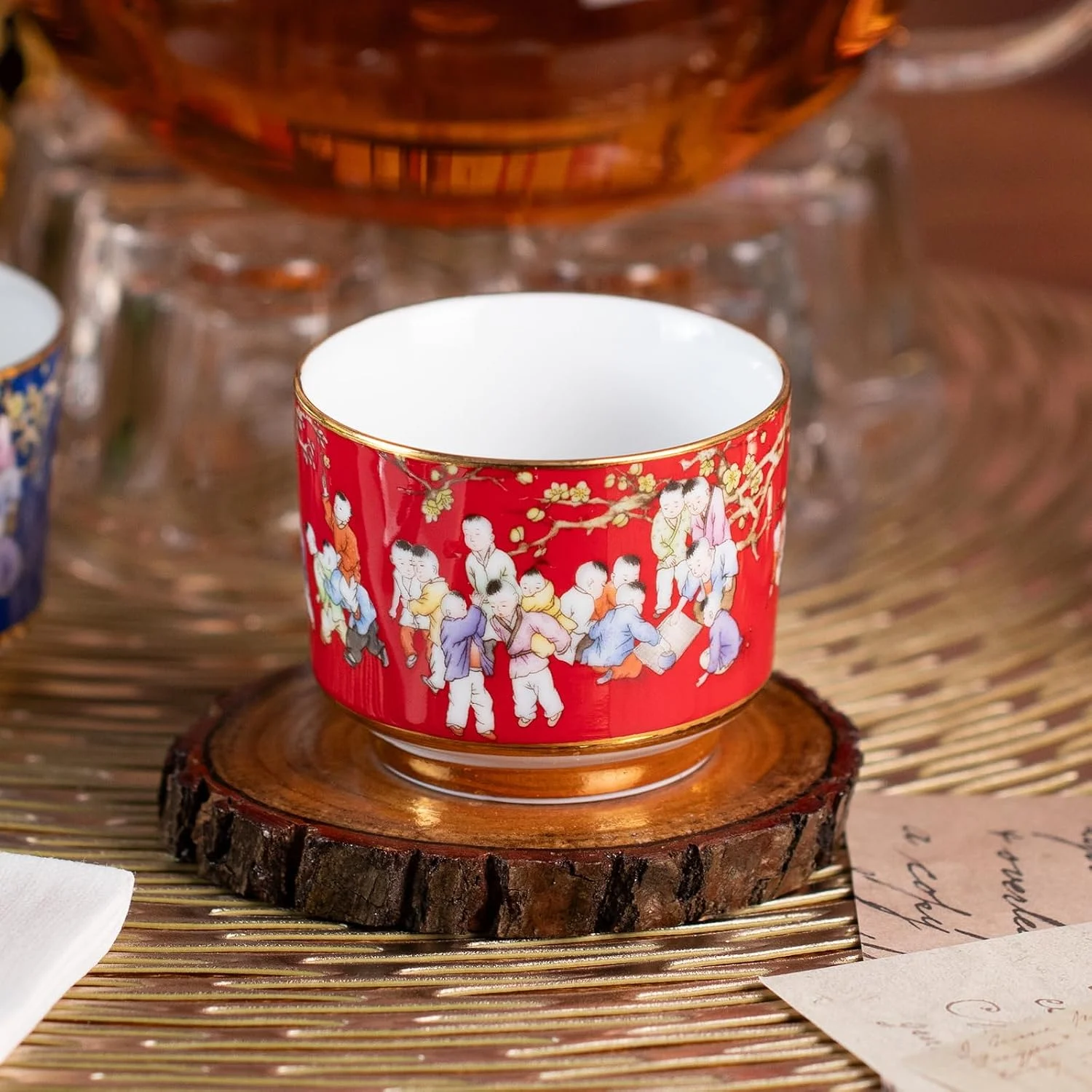 Close view of the red KAMMAK porcelain tea cup and gold-tone trim