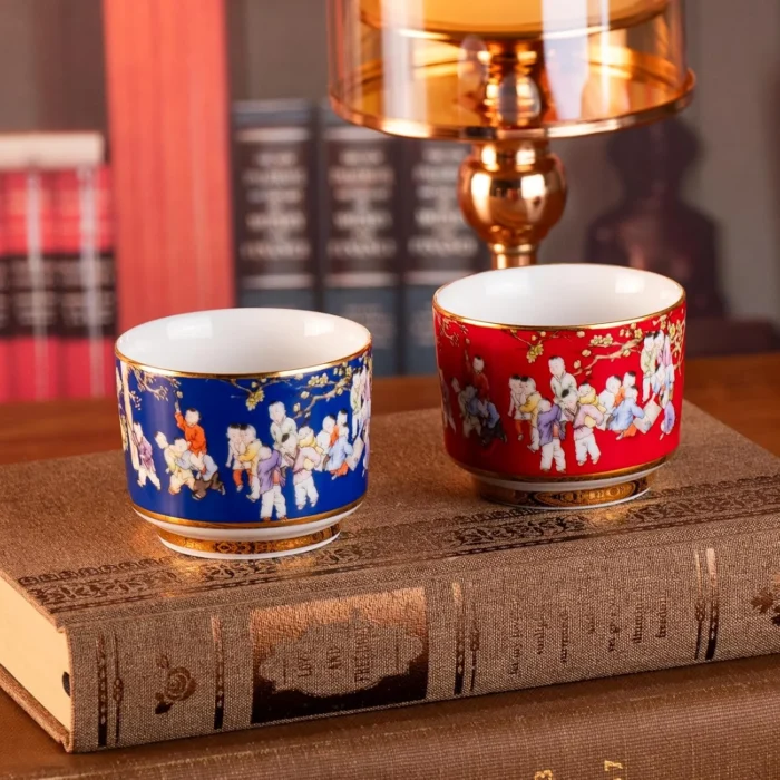 KAMMAK red and blue porcelain cups displayed on stacked books KAMMAK 7KPSP424N ceramic cup and saucer decorative craft detail image 7