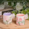 KAMMAK tulip and lotus ceramic mugs with care guidance icons KAMMAK 7KPSP434N ceramic cup and saucer styled home decor setting image 5